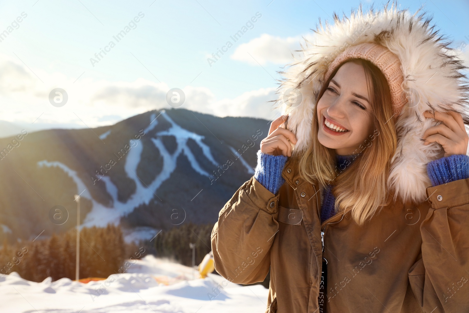 Photo of Happy young woman spending winter vacation in mountains. Space for text