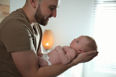 Father with his newborn son at home