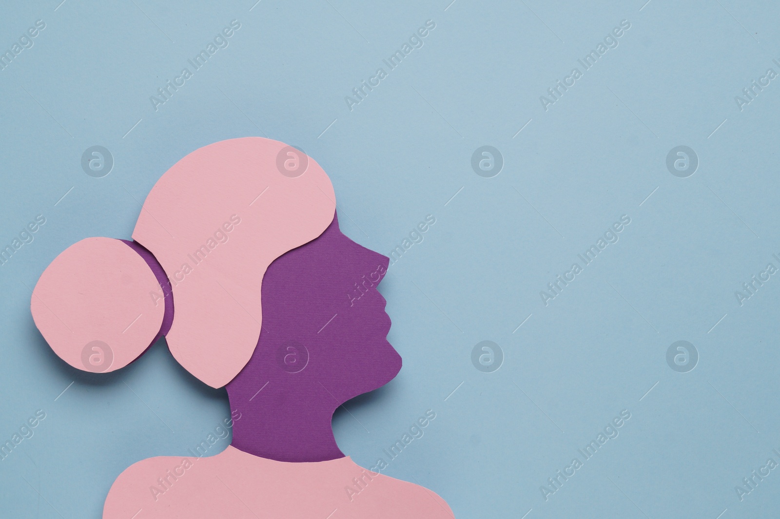 Photo of Woman's health. Female paper figure on light blue background, top view with space for text