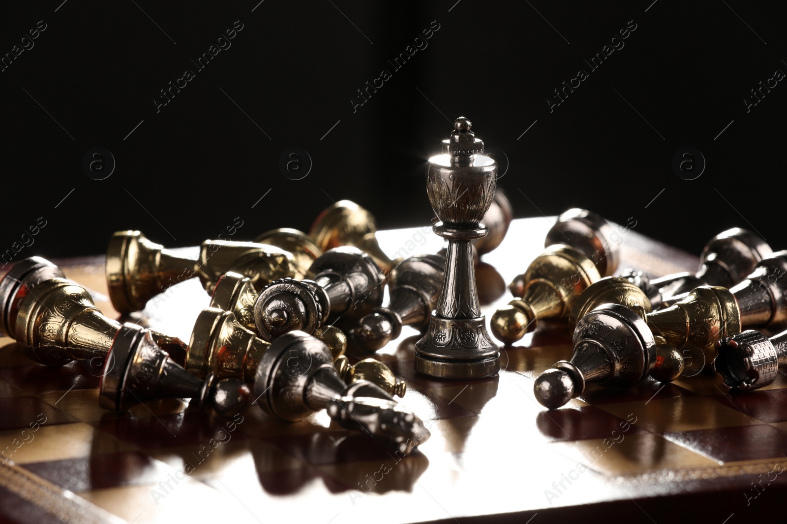 Photo of Chessboard with game pieces on black background