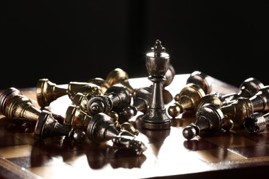 Chessboard with game pieces on black background
