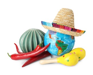 Globe with Mexican sombrero hat, ceramic cactus, maracas and chili peppers isolated on white