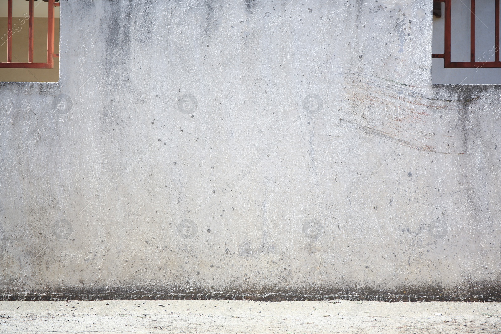 Photo of Beautiful old white wall with windows near concrete sidewalk outdoors