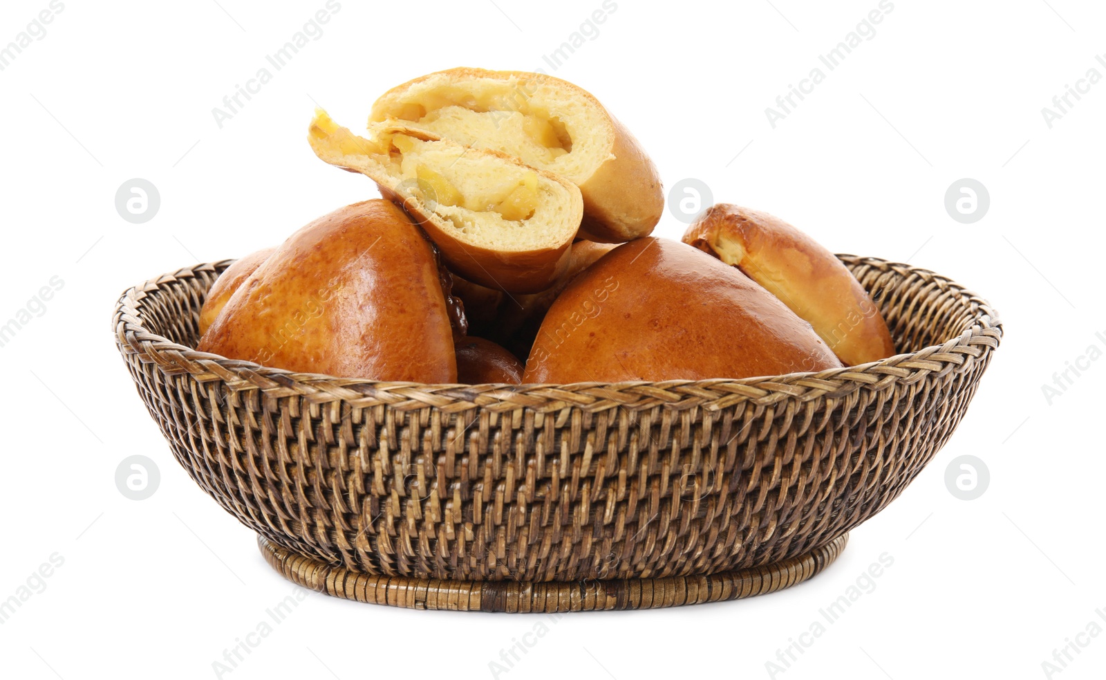 Photo of Delicious baked apple pirozhki in wicker basket on white background