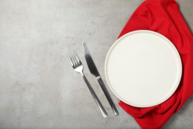 Photo of Setting with beautiful cutlery on textured table, top view. Space for text