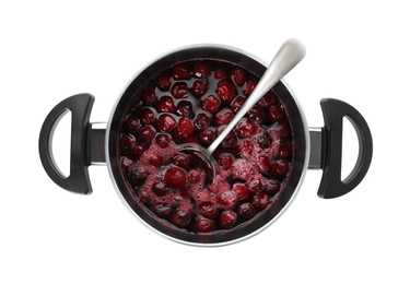 Photo of Pot with cherries in sugar syrup on white background, top view. Making delicious jam