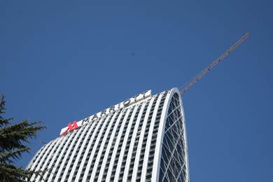 Photo of Batumi, Georgia - October 12, 2022: Mariott building against blue sky, low angle view