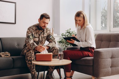 Psychologist working with military officer in office