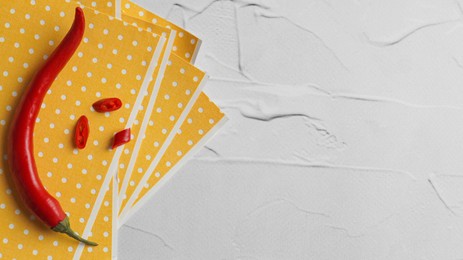 Photo of Pepper plasters and chili on white textured table, top view. Space for text