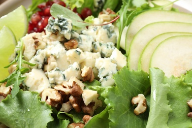 Photo of Delicious fresh salad with pear slices as background, closeup view