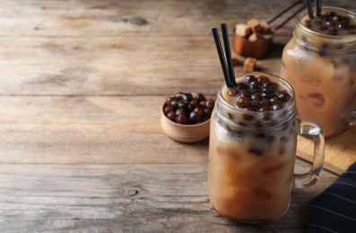 Tasty milk bubble tea on wooden table. Space for text