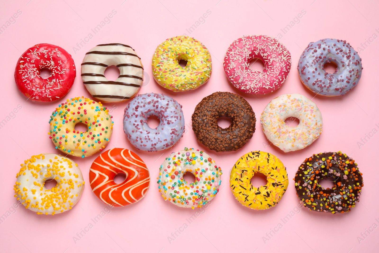 Photo of Delicious glazed donuts on pink background, flat lay