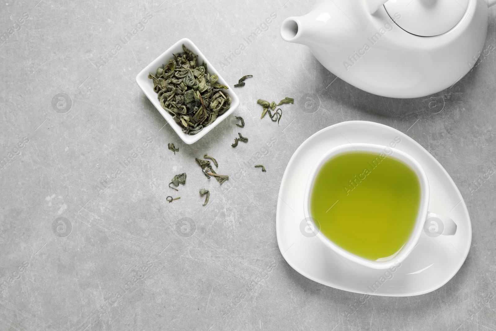 Photo of Flat lay composition with green tea on grey background