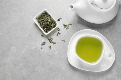 Photo of Flat lay composition with green tea on grey background