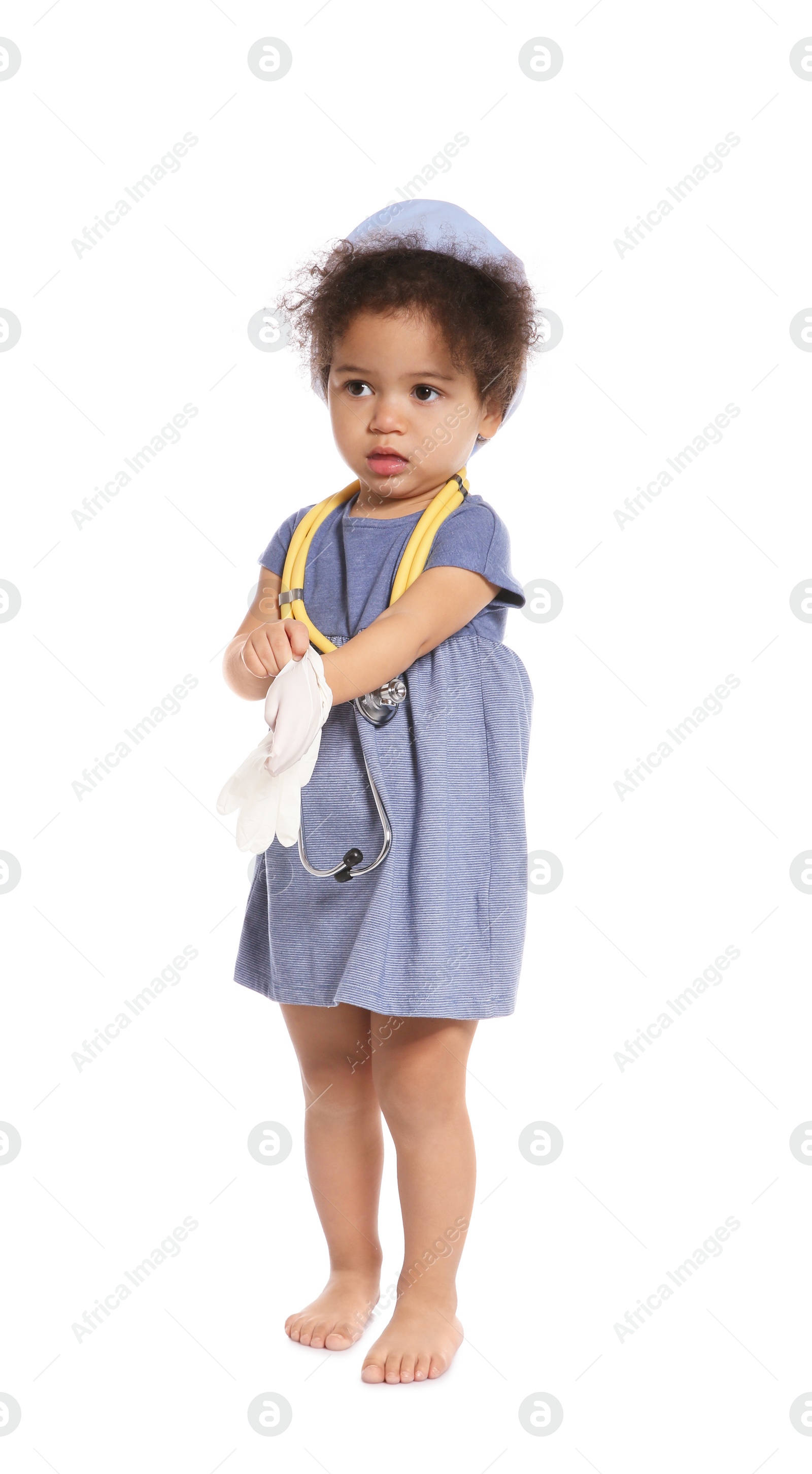 Photo of Cute African American child imagining herself as doctor while wearing rubber glove on white background