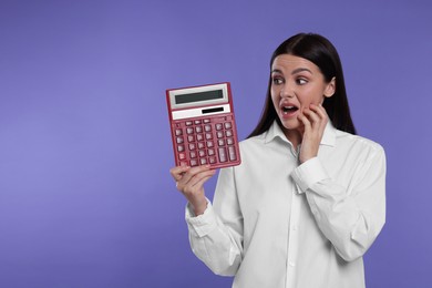Photo of Emotional accountant with calculator on purple background, space for text