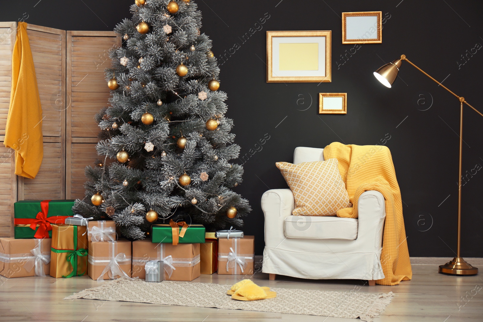 Photo of Stylish room interior with beautiful Christmas tree and gift boxes