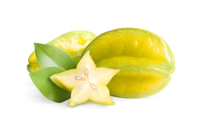 Cut and whole carambolas with green leaves on white background