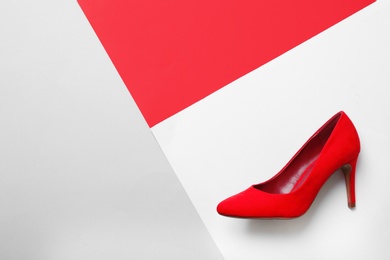 Photo of Stylish high heel shoe on color background, top view with space for text