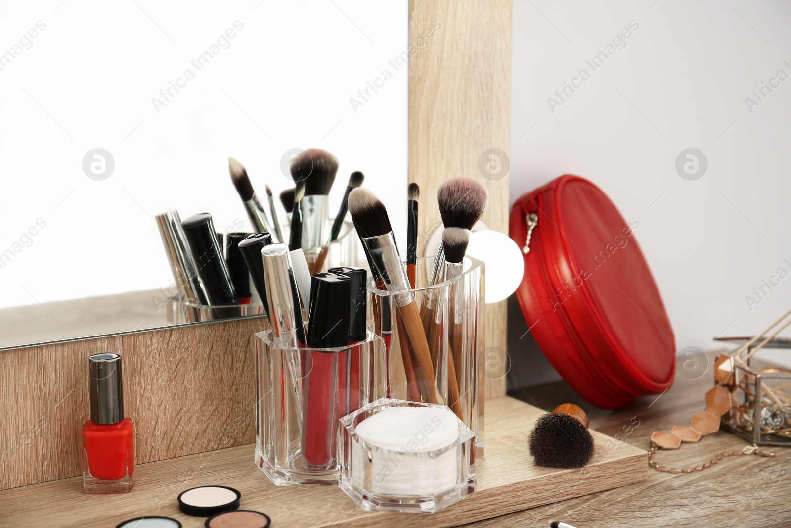 Photo of Makeup cosmetic products and tools on dressing table