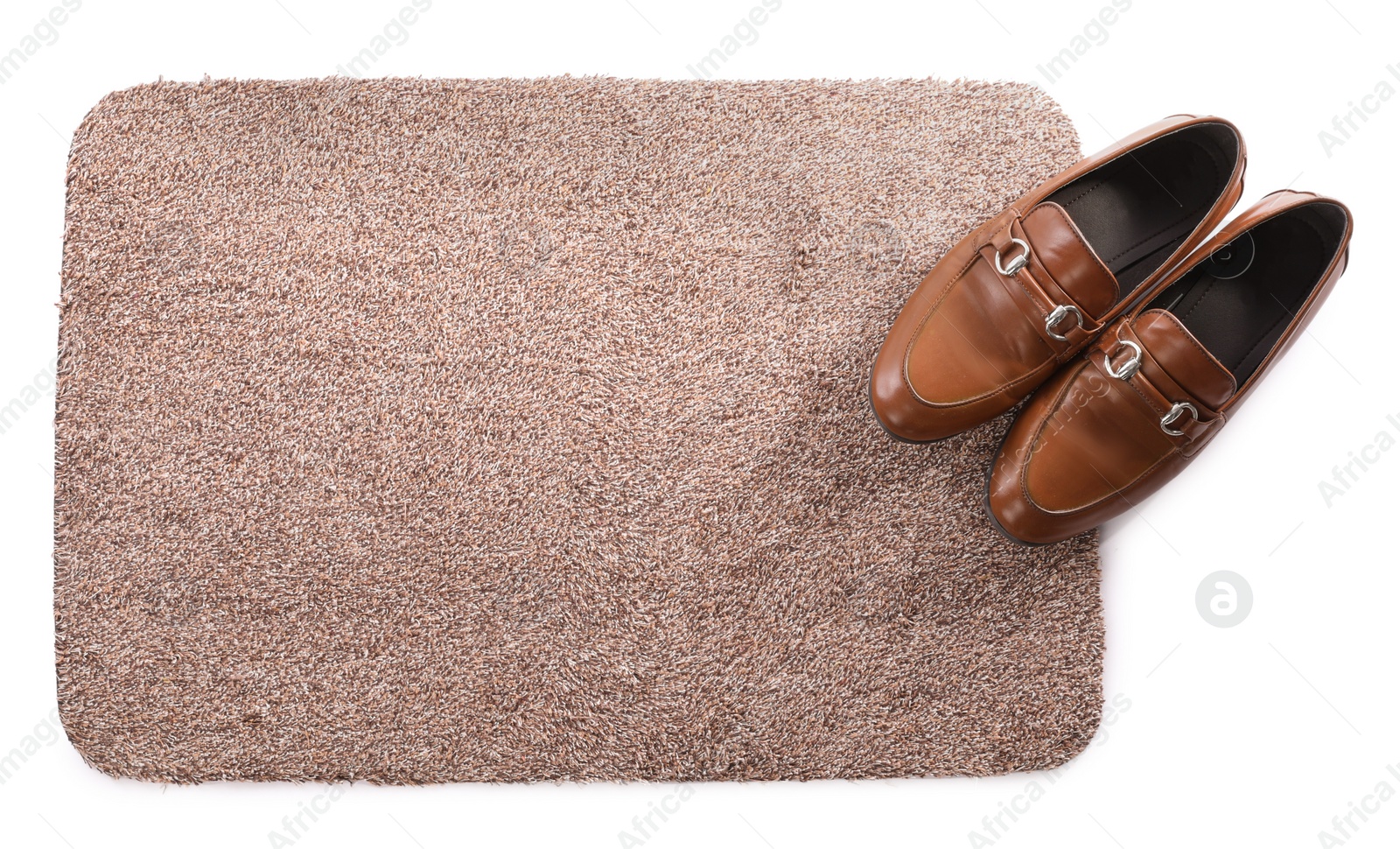 Photo of Stylish door mat with shoes on white background, top view