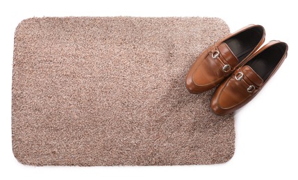 Stylish door mat with shoes on white background, top view