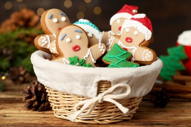 Photo of Delicious homemade Christmas cookies in wicker basket on wooden table