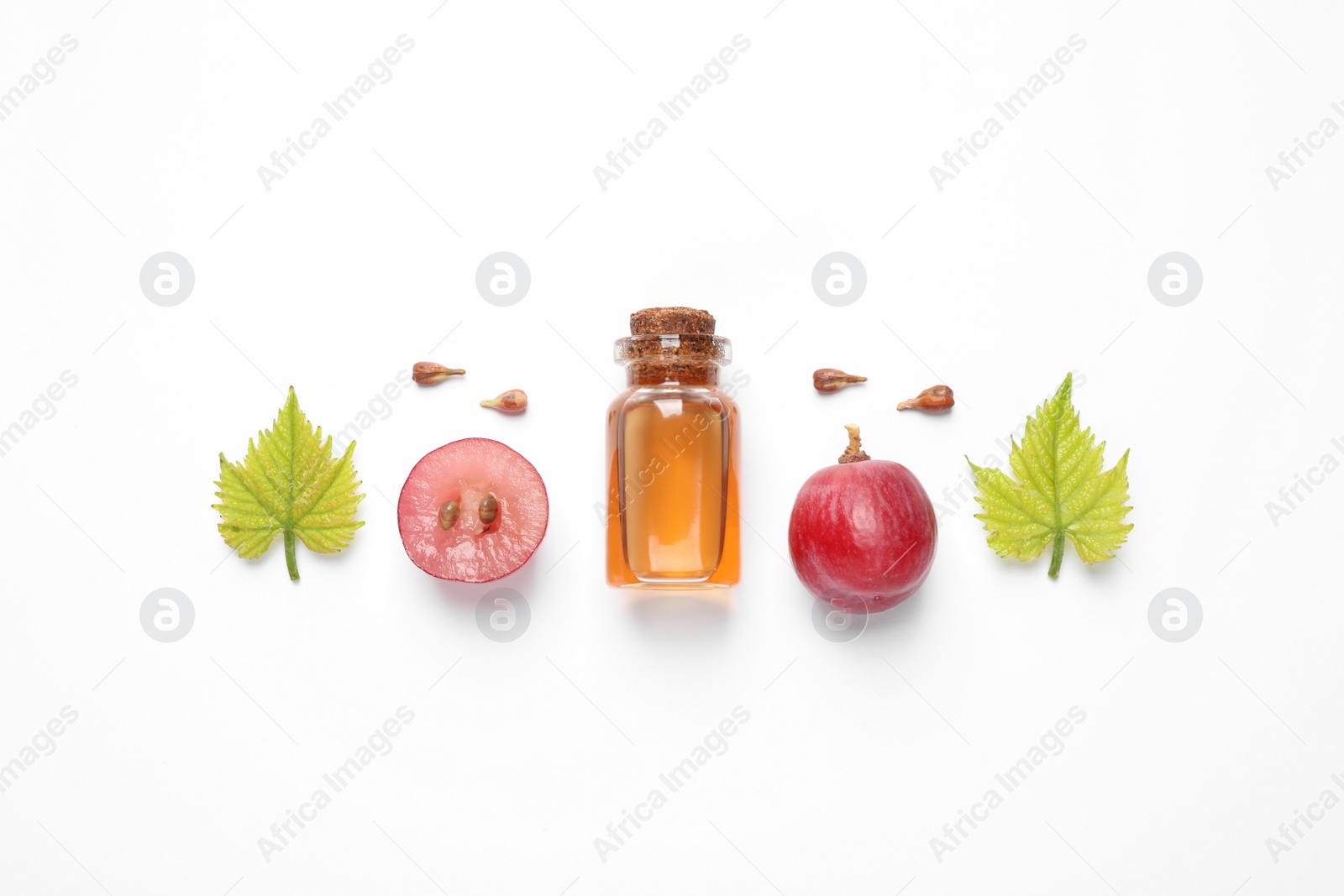 Photo of Flat lay composition with natural grape seed essential oil on white background. Organic cosmetics