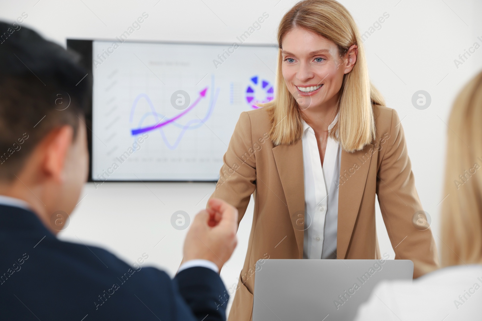Photo of Businesswoman having meeting with her employees in office