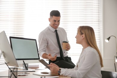 Man flirting with his colleague during work in office