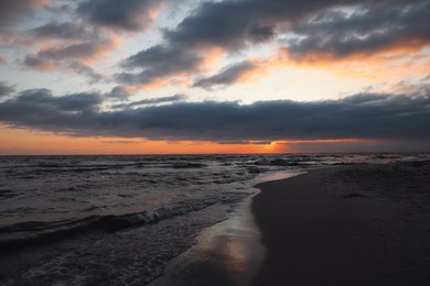 Picturesque view of cloudy sky over sea at sunset