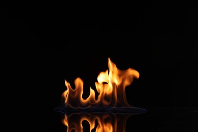 Photo of Beautiful view of flaming vodka on black background