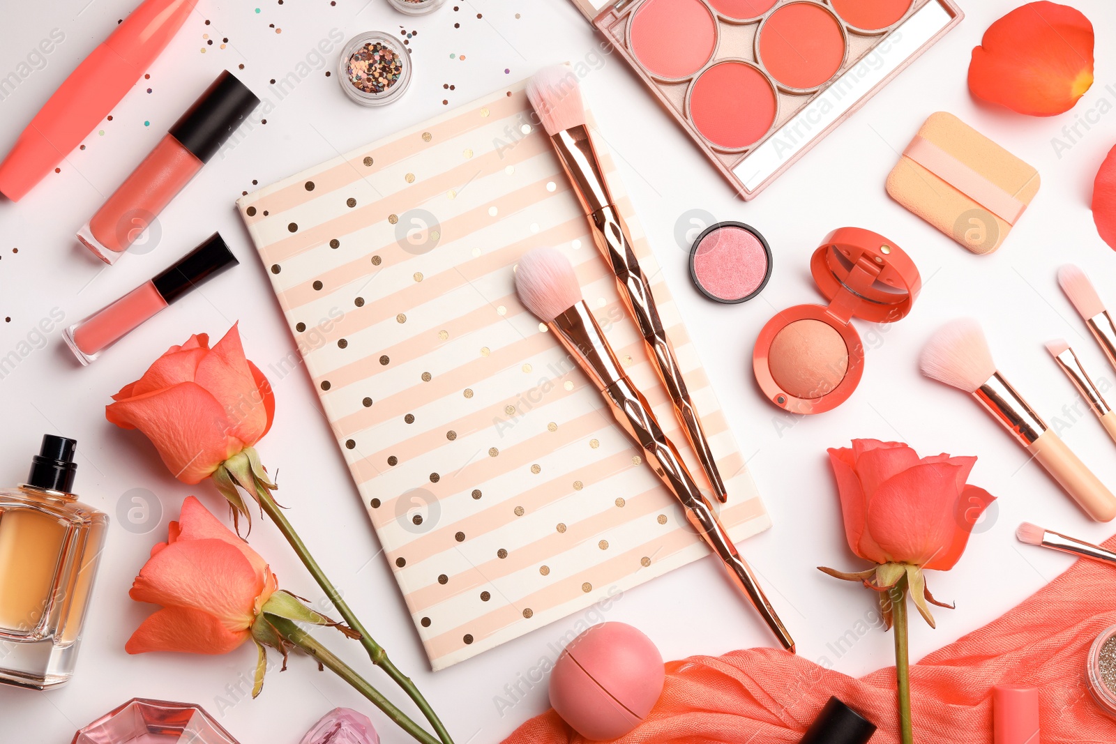 Photo of Flat lay composition with coral accessories, notebook and roses on white background