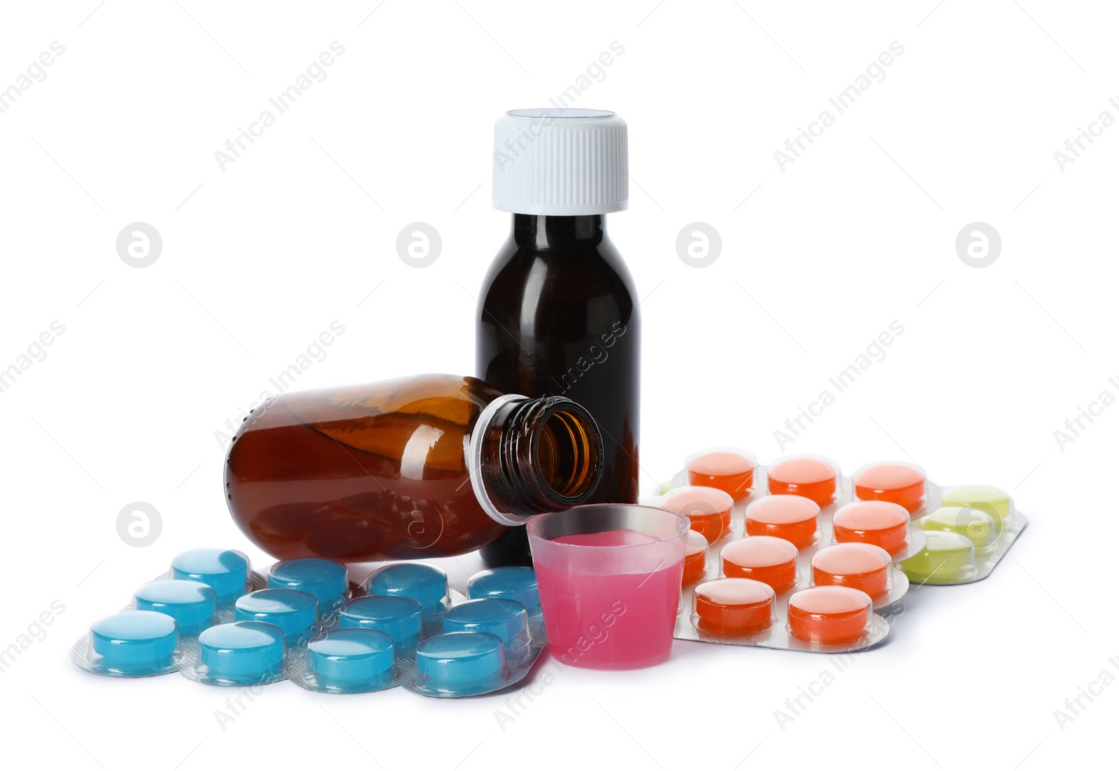 Photo of Cough syrup and different pills on white background