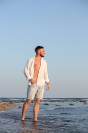 Young man enjoying sunny day on beach