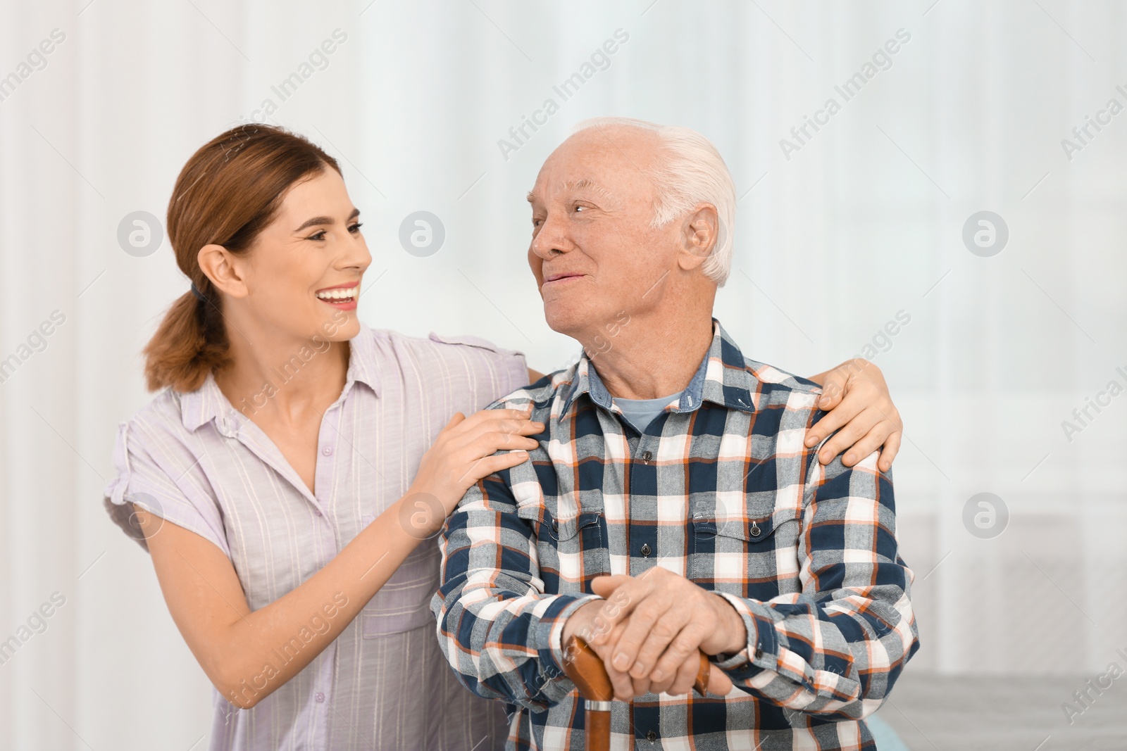 Photo of Elderly man with female caregiver at home