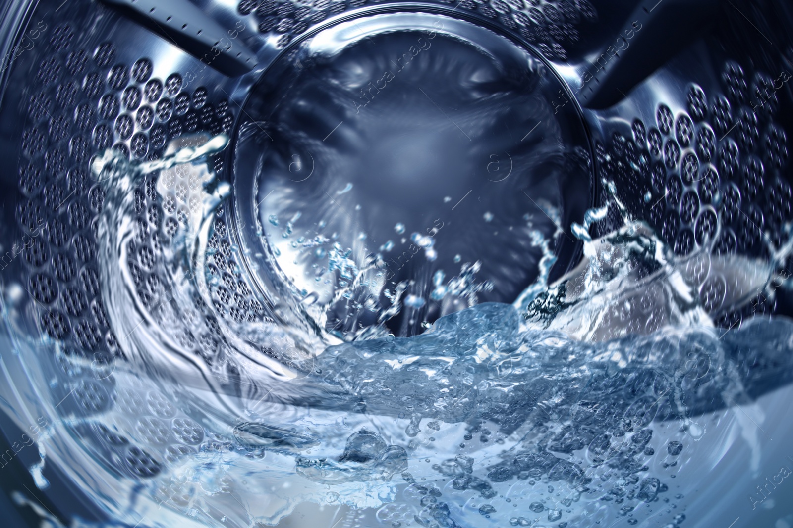 Image of Washing machine drum with water, closeup view