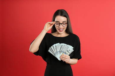Photo of Young woman with money on crimson background