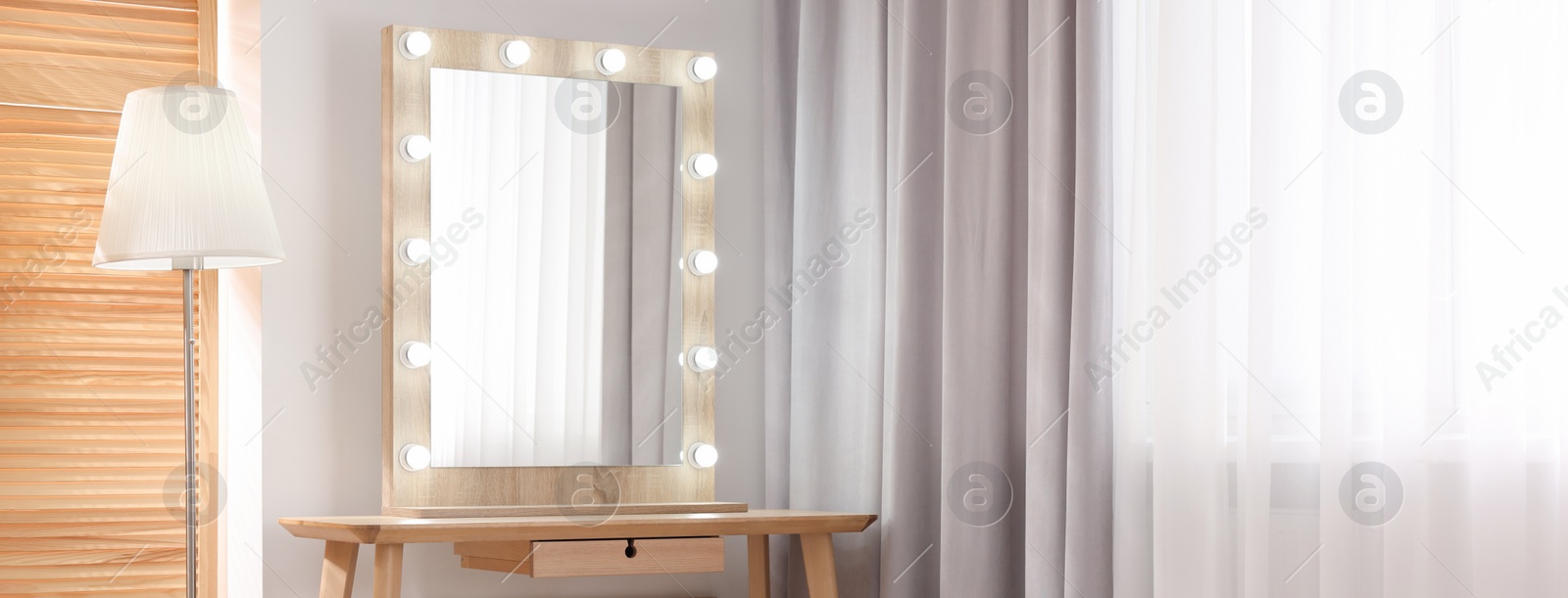 Image of Makeup room. Dressing table with mirror and lamp indoors, space for text. Banner design