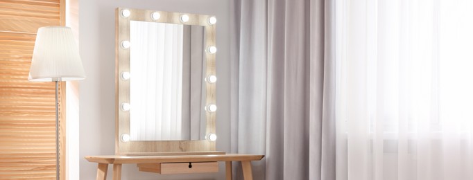 Makeup room. Dressing table with mirror and lamp indoors, space for text. Banner design