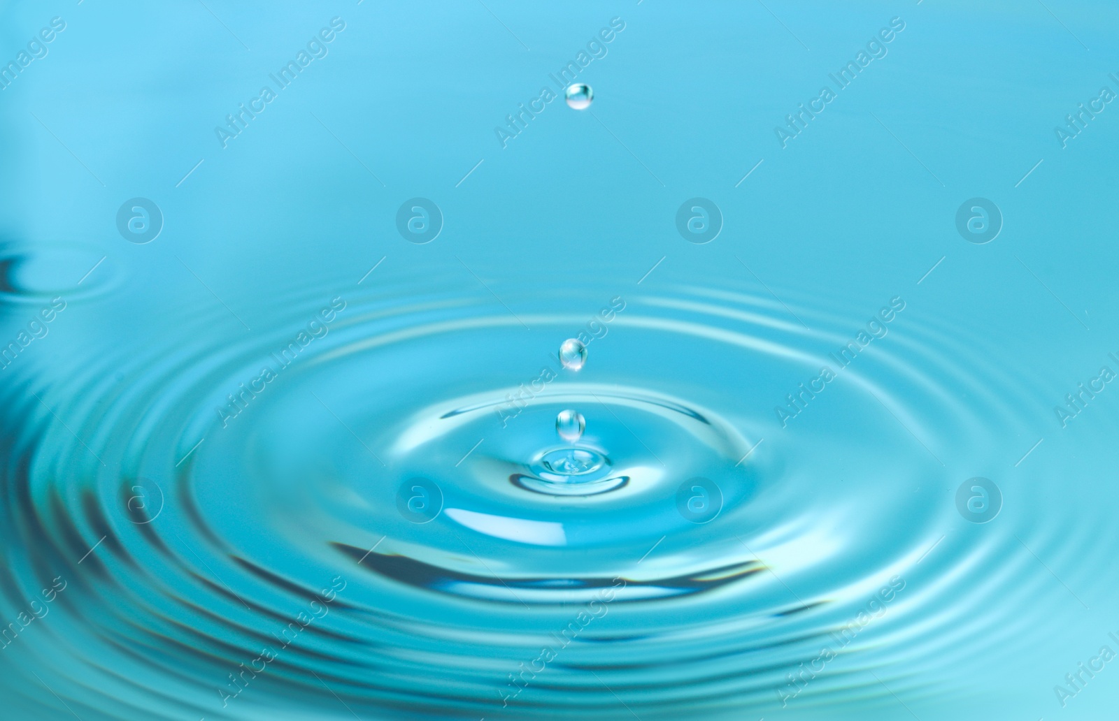 Photo of Splash of blue water with drop, closeup