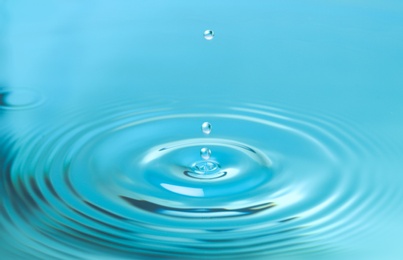 Splash of blue water with drop, closeup