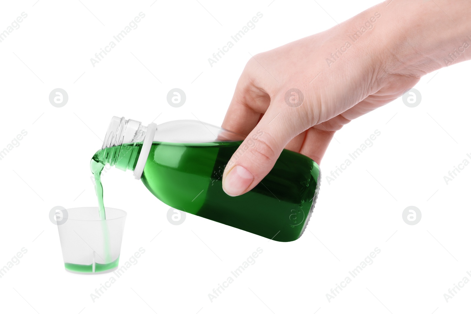 Photo of Woman pouring syrup into measuring cup from bottle isolated on white, closeup. Cough and cold medicine