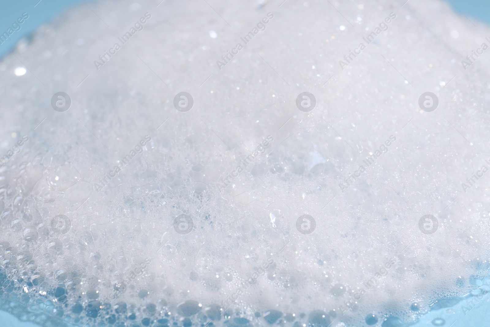 Photo of Texture of cleansing foam, closeup. Skin care cosmetic