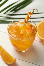 Photo of Delicious orange soda water on white wooden table