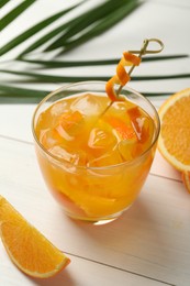 Delicious orange soda water on white wooden table