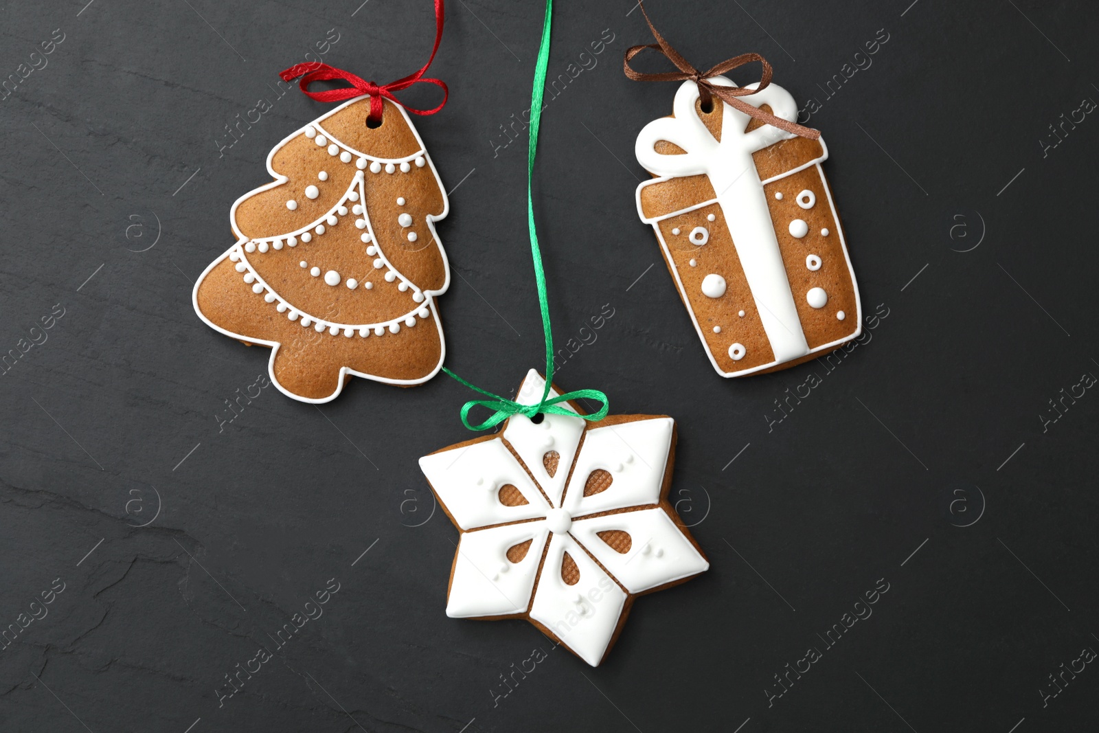 Photo of Different delicious Christmas cookies on black table, flat lay