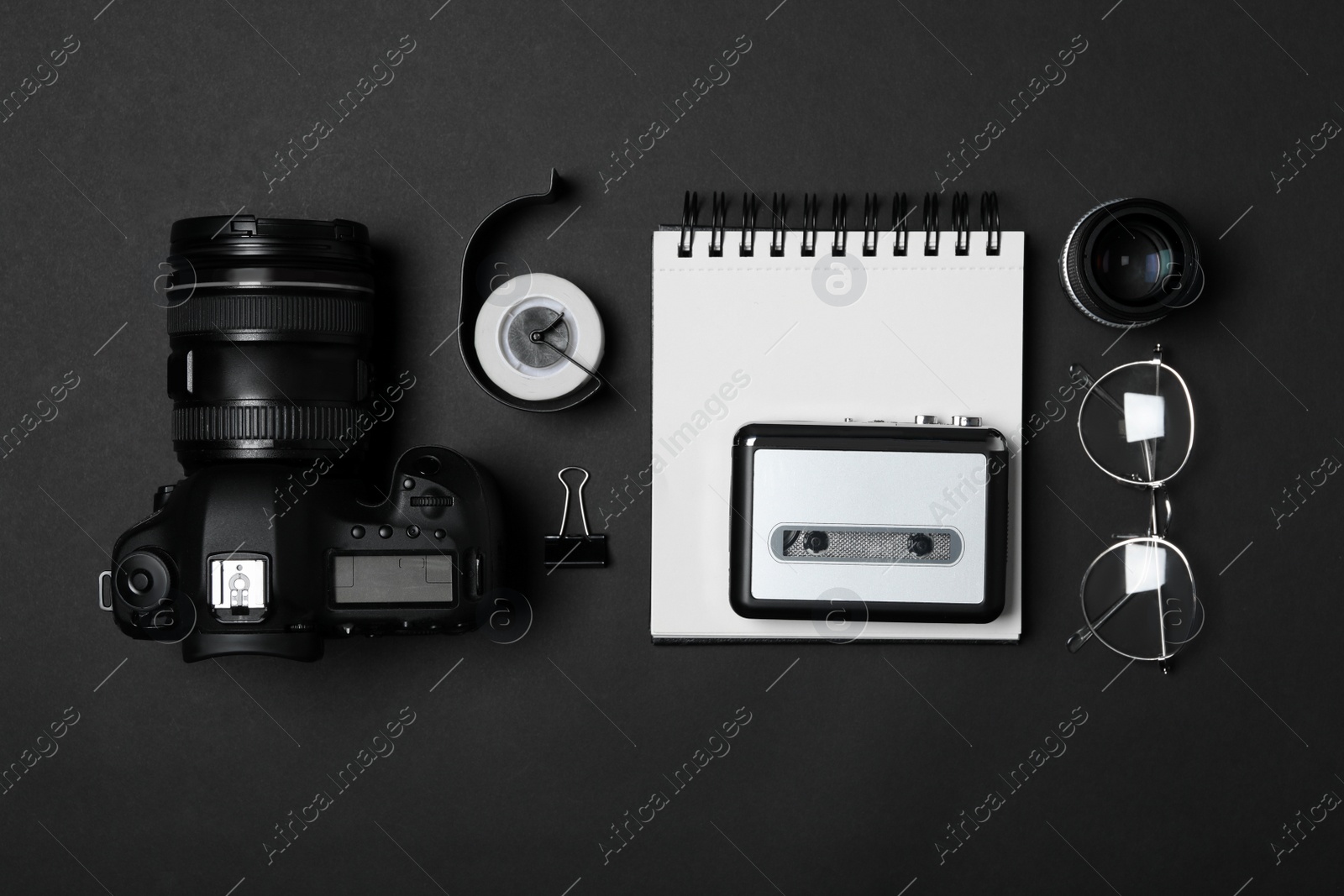 Photo of Flat lay composition with equipment for journalist on black background