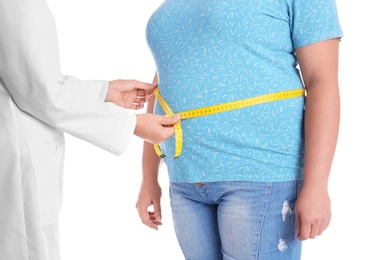 Photo of Doctor measuring fat woman's waist on white background, closeup. Weight loss