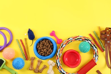 Flat lay composition with different pet goods on yellow background, space for text. Shop assortment